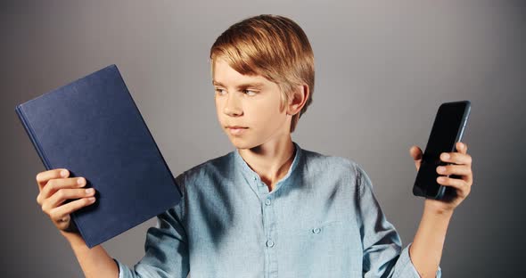 Boy Preferring Book To Smartphone