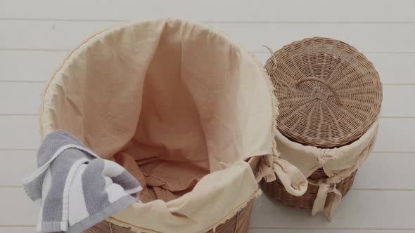 Top View  Stop Motion of Dirty Clothes are Filling Into a Laundry Basket on a Floor alt
