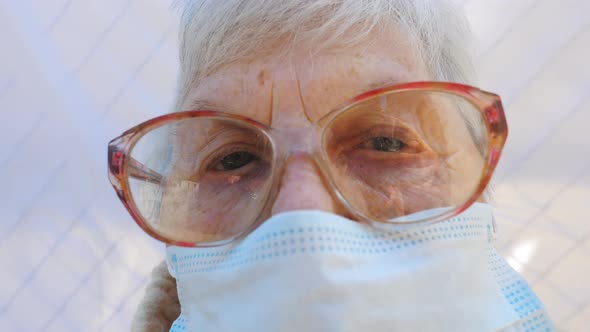 Close Up Face of Granny in Protective Mask From Virus alt