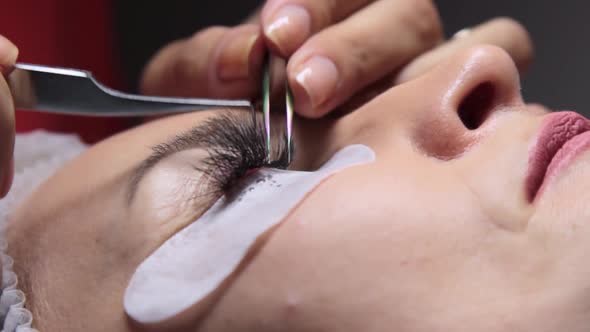 in a Beauty Salon a Woman Undergoes an Eyelash Extension Procedure