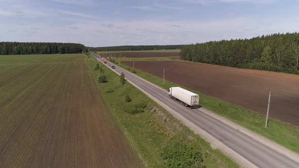 Aerial view of truck driving on a straight asphalt road 08 alt
