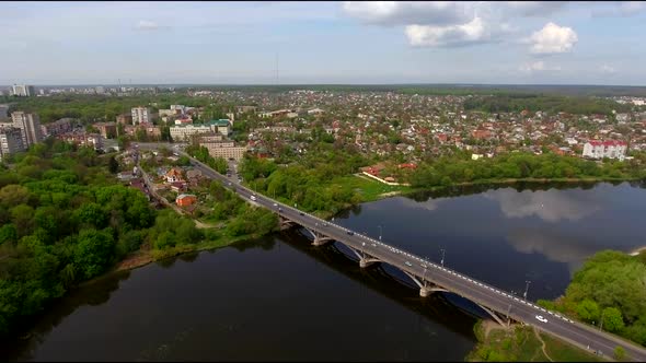 Aerial view of the city bridge with a reflection of clouds. Up.