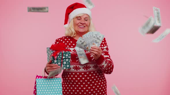 Senior Grandmother Woman Spending Money on Christmas Holiday Holding Sale Gift Boxes Shopping Bags alt