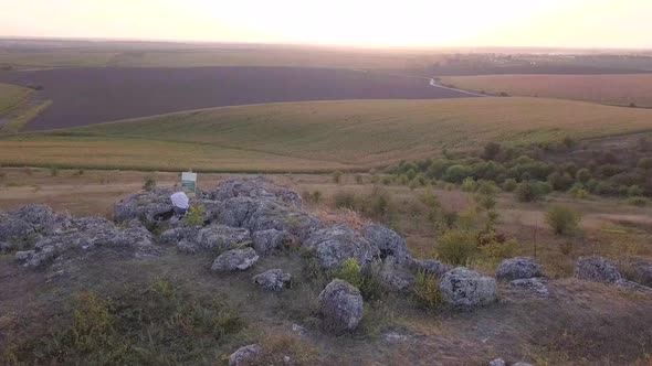 Girl artist paints a picture with oil paints. Aerial view alt