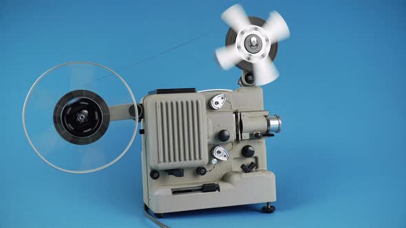 Rewinding Filmstrip On A Retro Movie Projector On A Blue Background