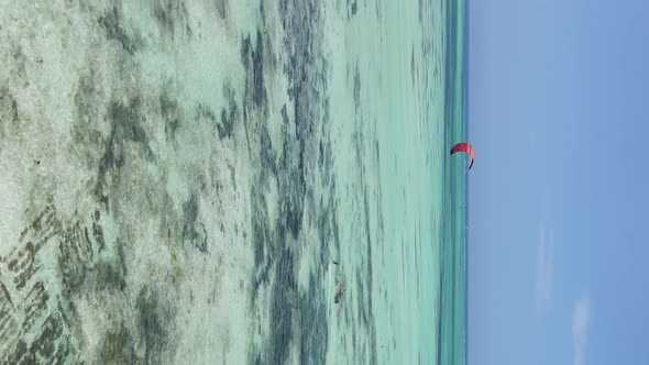 Vertical Video Kitesurfing Near the Shore of Zanzibar Tanzania Aerial View alt