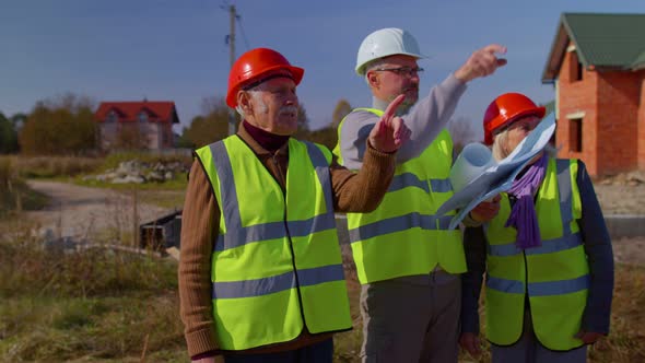 Real Estate Agent Manager Architect Showing Modern House to Senior Grandparents Family Client Couple alt