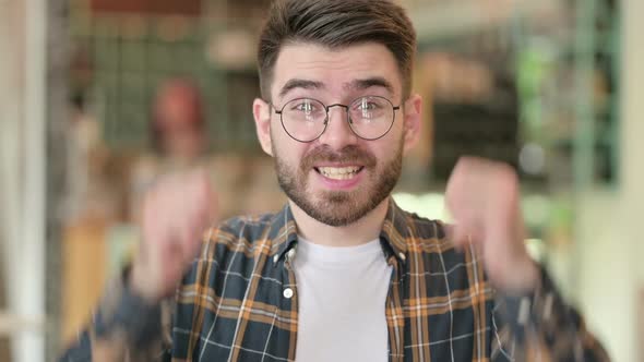 Portrait of Ambitious Young Man Celebrating Success alt
