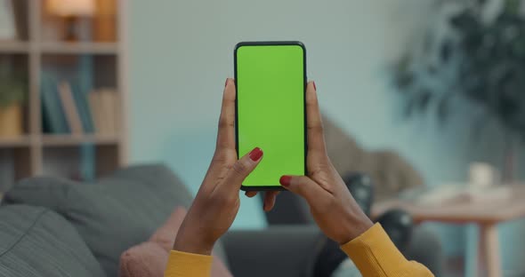African Woman Typing Messages on Mobile with Green Screen alt