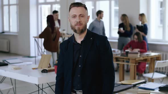 Portrait of Relaxed Middle Aged Caucasian Sales Business Coach Man in Black Formal Suit Looking at alt