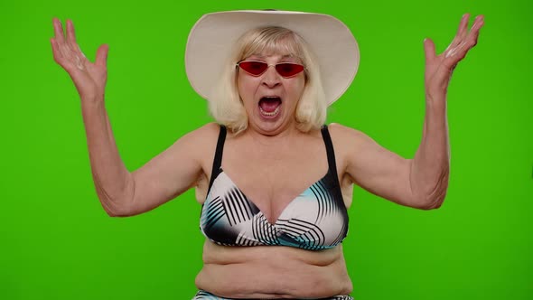 Senior Woman Tourist Raising Hand in Victorious Gesture Dancing Shouting Yes Celebrating Success alt