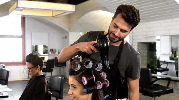 Male hairdresser styling customers hair alt