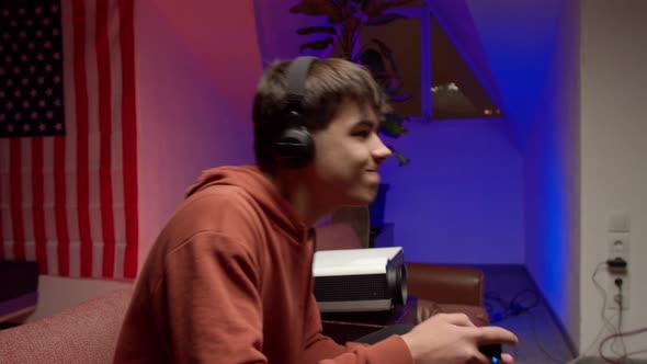 Young Man in Headphones Playing Video Game