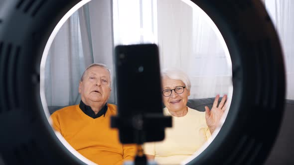 Elderly Couple Giving an Interview or Recording Video Message for Family alt