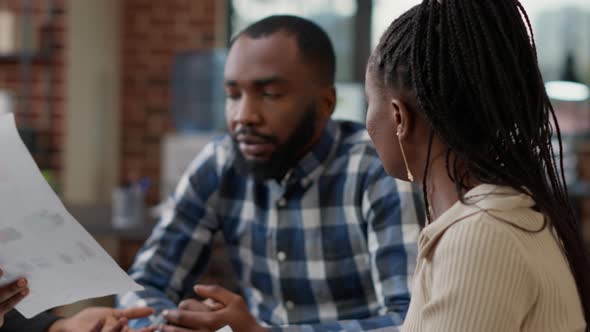 Team of Business People Brainstorming Ideas and Looking at Files alt