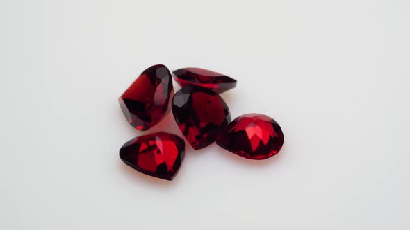 Natural Red Garnet Gemstone on the White Background on the Turning Table alt