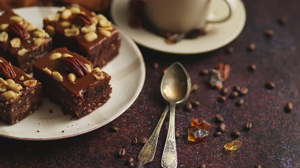 Chocolate Cake with Caramel Frosting, Pecans and Hot Coffee, on Rustic Background. Freshly Baked alt