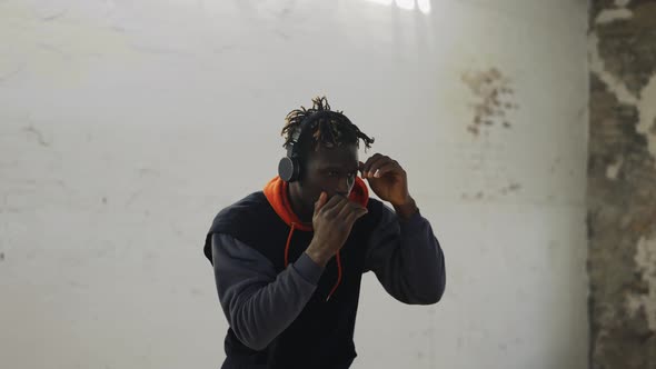 Afro American Young Male Boxer Practicing Shadow Boxing in Headphones alt
