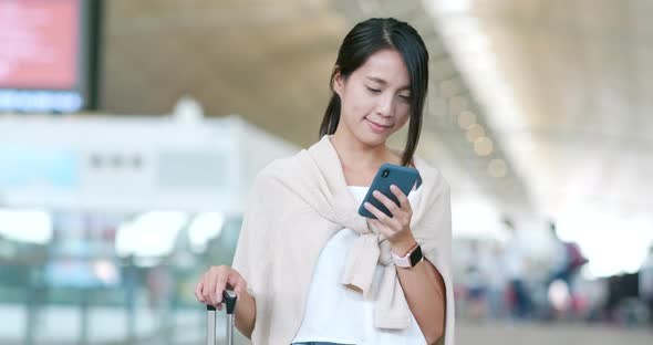 Young woman use of mobile phone in the airport alt