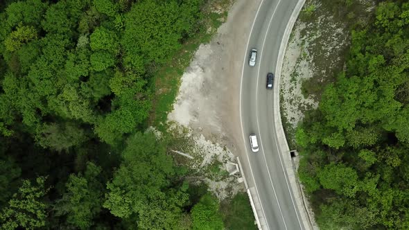 Aerial Top Down  View of Car Driving on Rural Road in Forest alt
