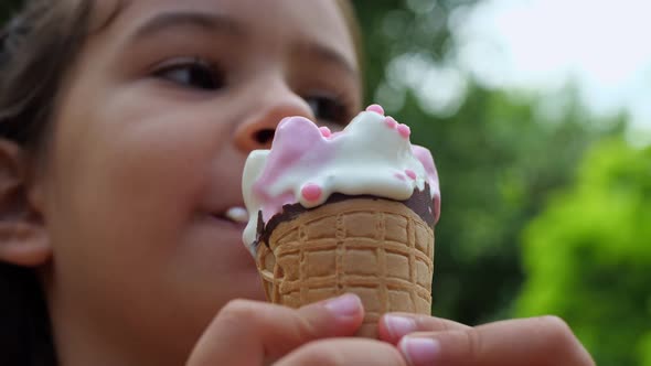 A child enjoying ice cream on a hot summer day. Melted ice cream in the hands of a child.
