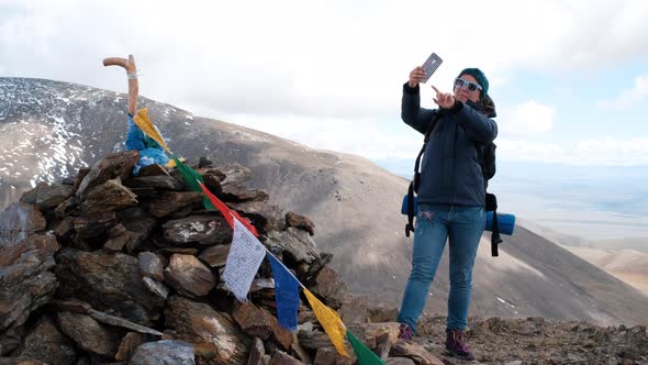 Woman Hiker Taking Selfie on the Top of Mountain alt