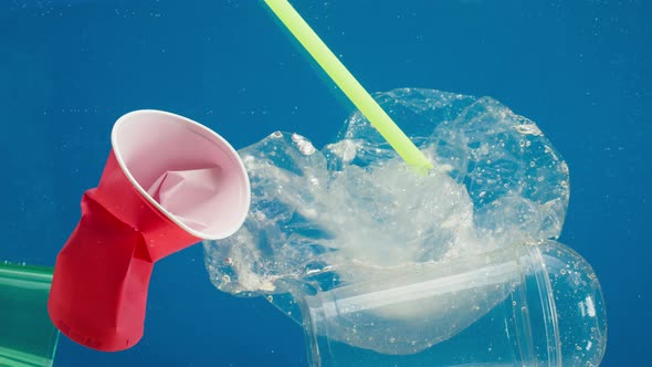 Plastic Trash in Ocean Water Sea Pollution Caps and Glasses Ecology Problems Waste and Garbage alt