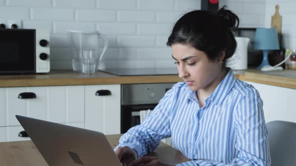 Concentrated Millennial Indian Female College Student Woman Doing University Assignment. alt
