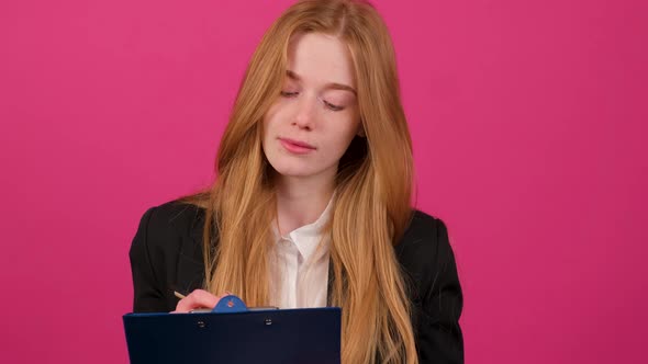 Close Up of a Businesswoman Write on a Paper Isolated on Pink Background alt