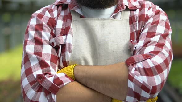 Greenhouse Worker in Apron and Gloves Looking Camera, Horticultural Business