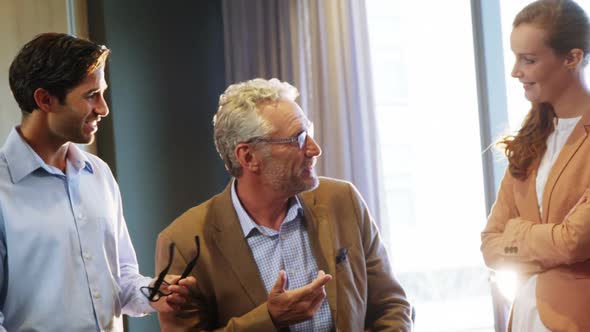 Businessman and coworkers discussing in meeting alt