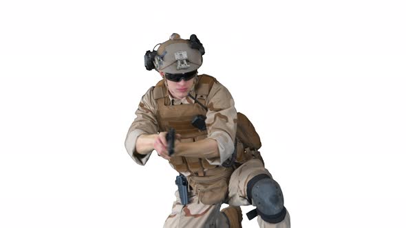 Soldier is Shooting with Hand Pistol Sitting on His Knee on White Background