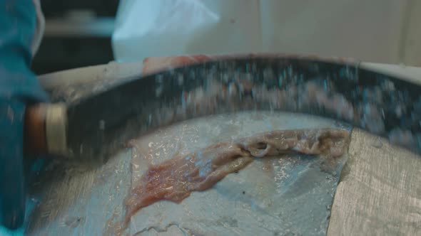 Curved blade used to scrape fatty meat from salmon skin alt