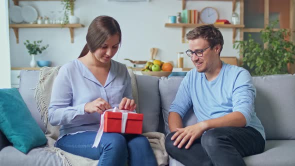 Ordering Gifts Online. A Man Gives a Woman a Gift that He Ordered Through the Site, an Online Store. alt