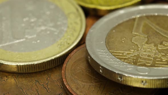 Macro shot of euro coins of different values: one uro, two euro, cents, etc. Macro shot, rotating vi alt