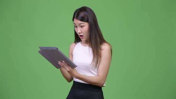 Young Beautiful Asian Businesswoman Using Digital Tablet