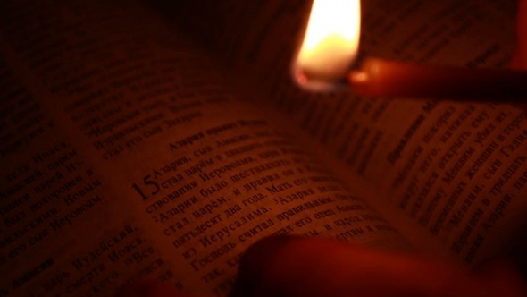 Burning Candle on a Bible