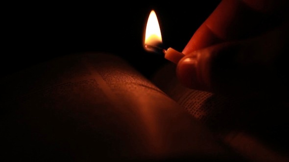 Burning Candle on a Book