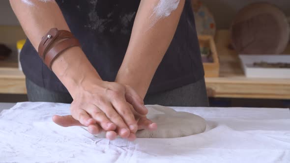 Female Sculptor Is Pugging and Kneading Clay for Creating Pottery Ceramics. Art and Handicraft
