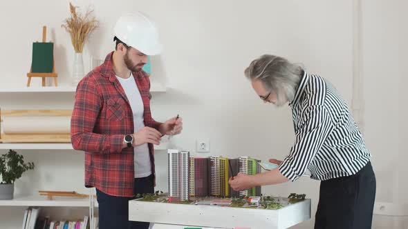 Young Engineer Work with Senior Architect in the Office. alt