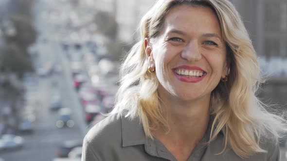 Charming Mature Happy Woman Laughing To the Camera on Urban Background alt