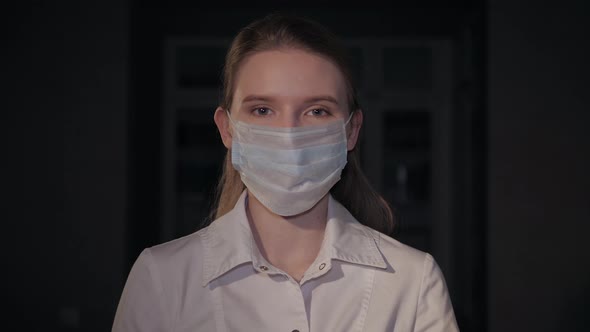 Front view close up female portrait in healthcare professional wearing a mask