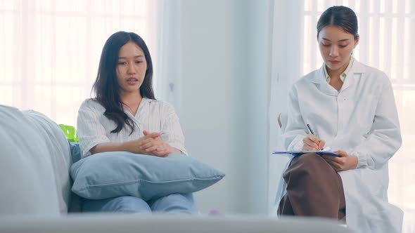 Asian psychology doctor examine and listen to woman patient at home. alt