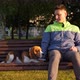 Handsome beagle lie down on bench near sitting man, look around - VideoHive Item for Sale