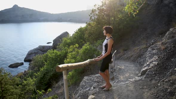 Young Woman Is Staying on Golitsyn Trail. Cute Girl Is Posing on Plain Air. Beautiful Landscape at alt
