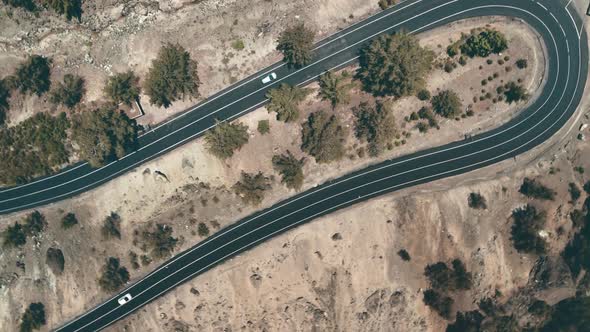 Top Down Aerial of Cars Drive Winding Highland Road in Mountain Countryside in Cyprus