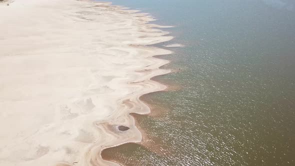 Drone shot of pattern in the river sand alt