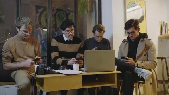 Businessmen Using Smartphones in Cafe, Freelancers Having Break During Meeting alt