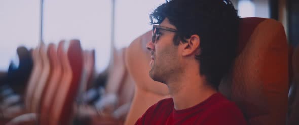 A man sitting in the refreshment room of the ferryboat alt