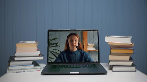 Young Woman Teaches Online Via Laptop